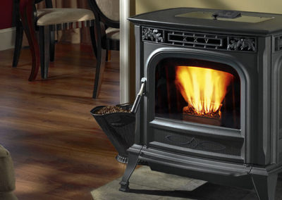 Small black pellet stove with fire burning