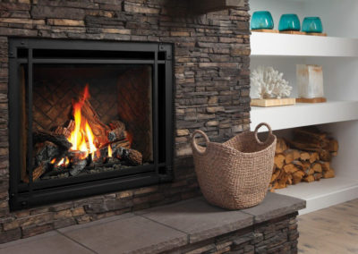 Dark stone gas fire place with a basket on the mantel