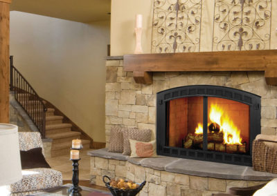 Wood beam mantel over a wood burning fire