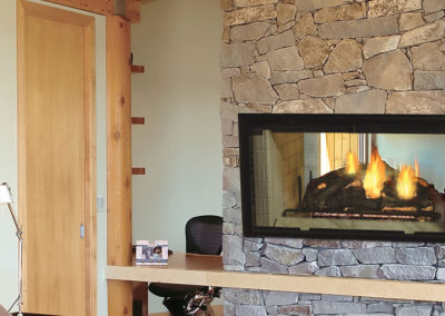 Stone wood burning fireplace and mantel
