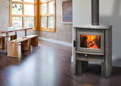 Large gray wood burning stove in dining room
