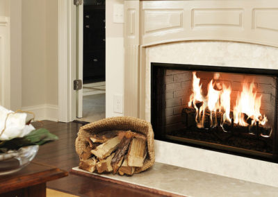 Wood burning fireplace in a cream colored room