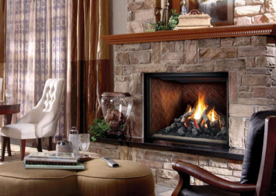 Stone gas fireplace with a roaring fire