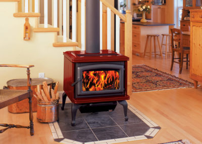 Red small wood burning stove in a home