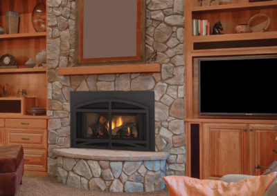 Large stone hearth in a wood paneled room
