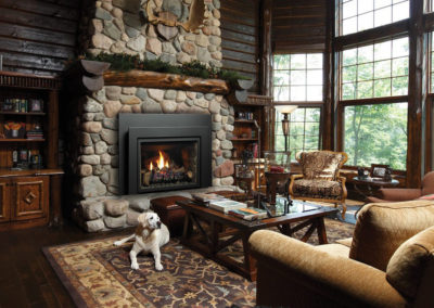 Large stone hearth in a log cabin