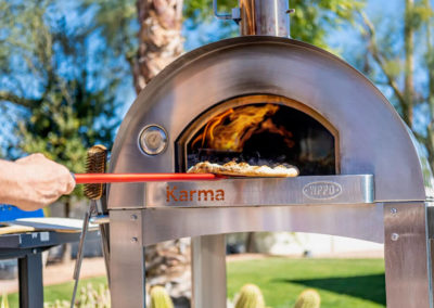 Pizza being put into a wood oven